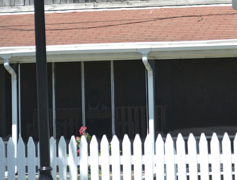 Look on the porch - behind the geranium